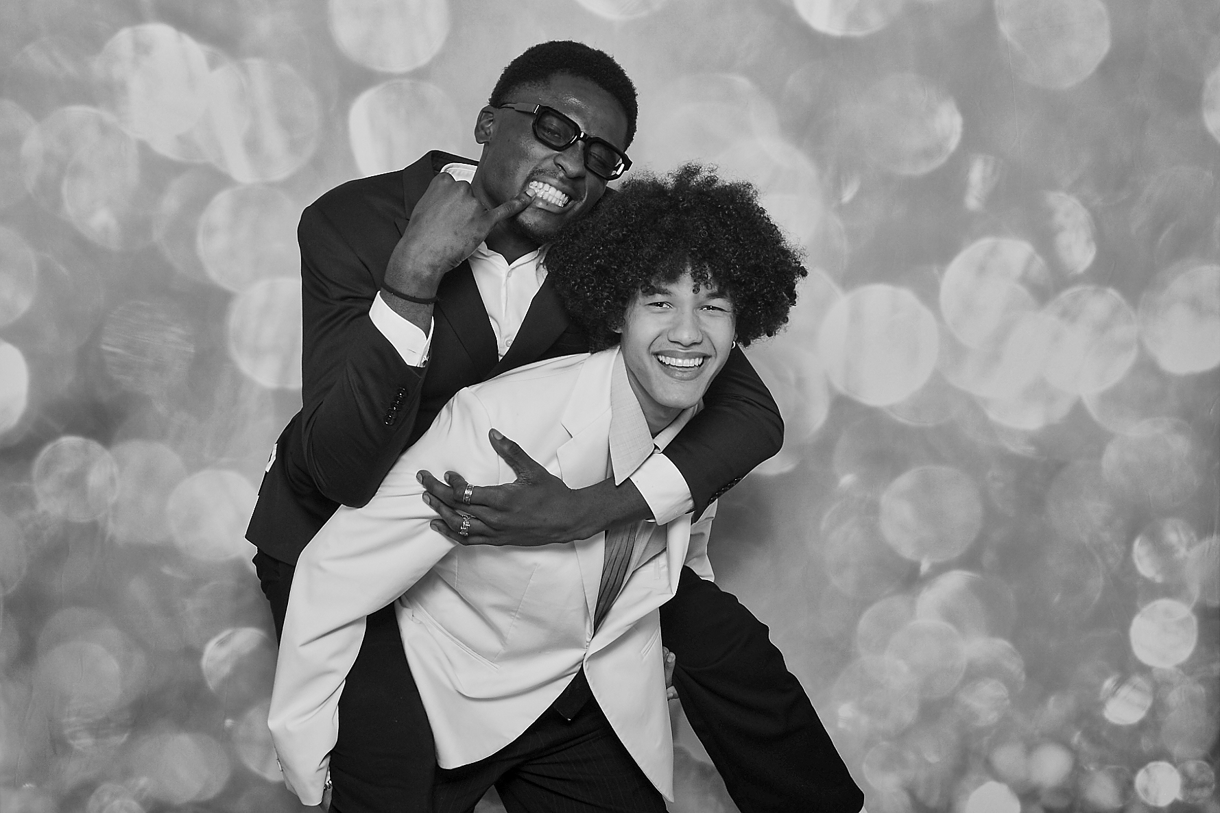 Vrienden die elkaar dragen tijdens een photobooth-sessie